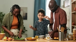 Family cooking together in a kitchen.