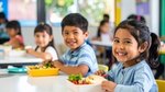 Children smiling while eating lunch in a classroom.